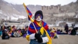 A youth with his face painted in the colors of the Tibetan flag takes part in a demonstration to mark Tibetan Women's Uprising Day to commemorate the 1959 revolt against Chinese occupation of Tibet, at the Polo Ground in Leh, on March 12, 2025.