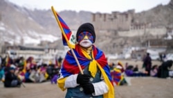 A youth with his face painted in the colors of the Tibetan flag takes part in a demonstration to mark Tibetan Women's Uprising Day to commemorate the 1959 revolt against Chinese occupation of Tibet, at the Polo Ground in Leh, on March 12, 2025.