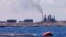 FILE - A general view of the port and Zawiya Oil Refinery, west of the city of Tripoli. Libya.