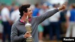 FILE - Rory McIlroy of Northern Ireland celebrates as he holds the Claret Jug after winning the British Open Championship at the Royal Liverpool Golf Club in Hoylake, northern England July 20, 2014. REUTERS/Cathal McNaughton (BRITAIN - Tags: SPORT GOLF) - 