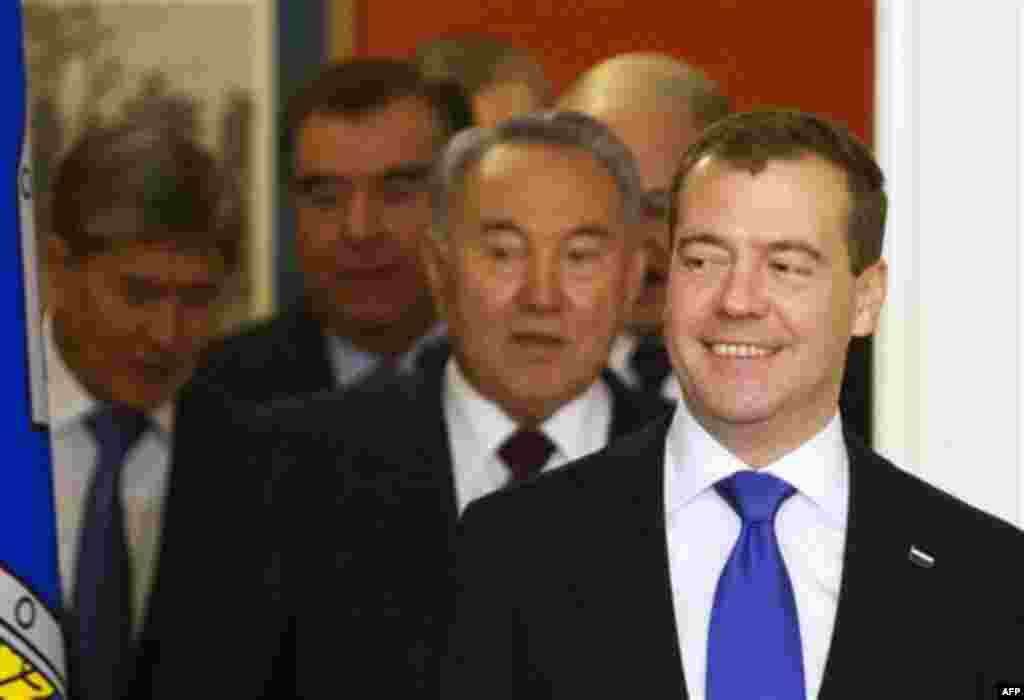 Russian President Dmitry Medvedev, right, followed by Kazakh President Nursultan Nazarbayev makes his way for a group photo during a summit of the Collective Security Treaty Organization in the Kremlin, Moscow, Tuesday, Dec. 20, 2011. (AP Photo/Misha Japa