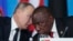 FILE - Russian President Vladimir Putin, left, speaks to South African President, Cyril Ramaphosa, right, during a plenary session at the Russia-Africa summit in the Black Sea resort of Sochi, Russia on Oct. 24, 2019