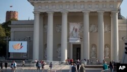 A banner with a portrait of Pope Francis is seen in front of the Cathedral Basilica of St. Stanislaus and St. Ladislaus in Vilnius, Lithuania, Sept. 21, 2018, ahead of the pontiff's upcoming visit to Lithuania, Latvia and Estonia.