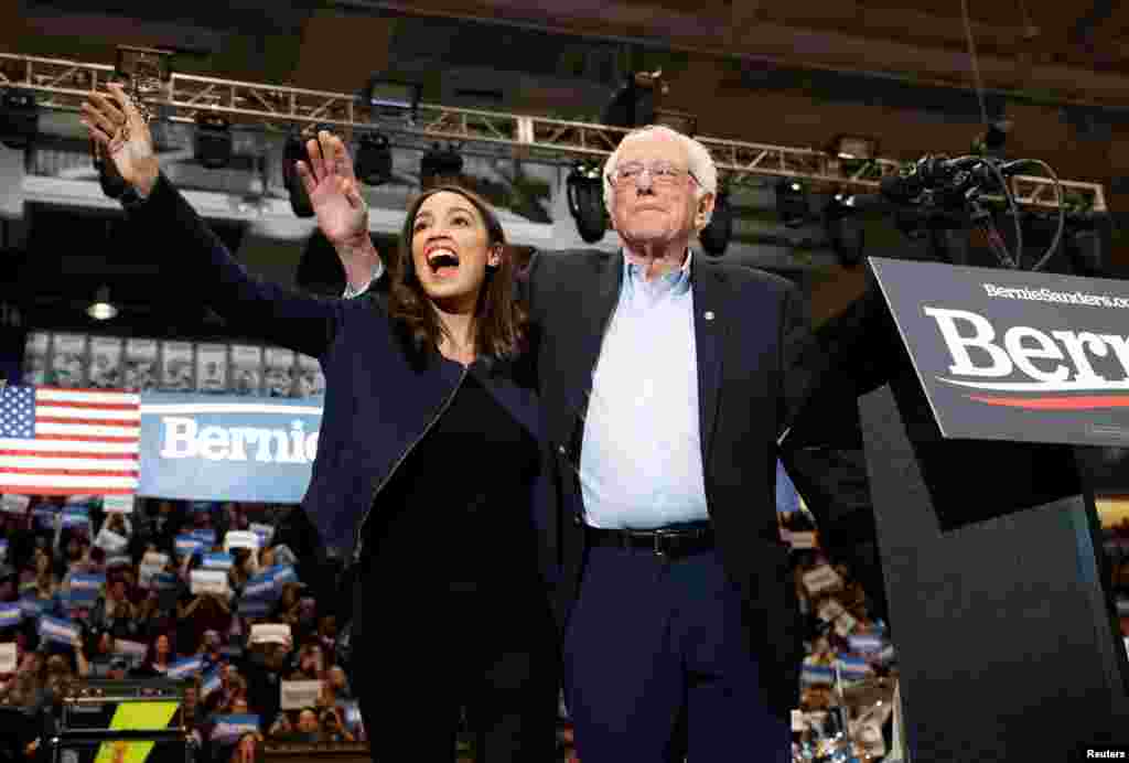 Democratic presidential candidate Senator Bernie Sanders takes the stage with Representative Alexandria Ocasio Cortez (D-NY) at a campaign rally at the University of New Hampshire in Durham, New Hampshire, Feb. 10, 2020.
