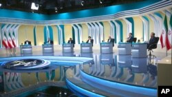 In this picture made available by the Young Journalists Club, Iranian presidential candidates for June 18 elections attend the final debate of the campaign at a state-run TV studio in Tehran, Iran, June 12, 2021.