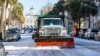 A snowplow clears Broad Street after a winter storm dropped ice and snow on Charleston, South Carolina, Jan. 22, 2025.