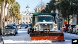 A snowplow clears Broad Street after a winter storm dropped ice and snow on Charleston, South Carolina, Jan. 22, 2025.