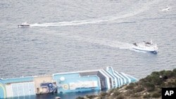 This picture shows a view of the cruise liner Costa Concordia aground in front of the harbor of the Isola del Giglio (Giglio island), January 18, 2012.