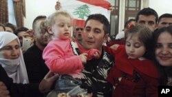 Lebanese policeman who was captured by al Qaeda-linked Nusra Front in Arsal, gets greeted by his family in Beirut, Dec. 1, 2015.