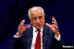 FILE - US envoy for peace in Afghanistan Zalmay Khalilzad speaks during a debate at Tolo TV channel in Kabul, Afghanistan, April 28, 2019.