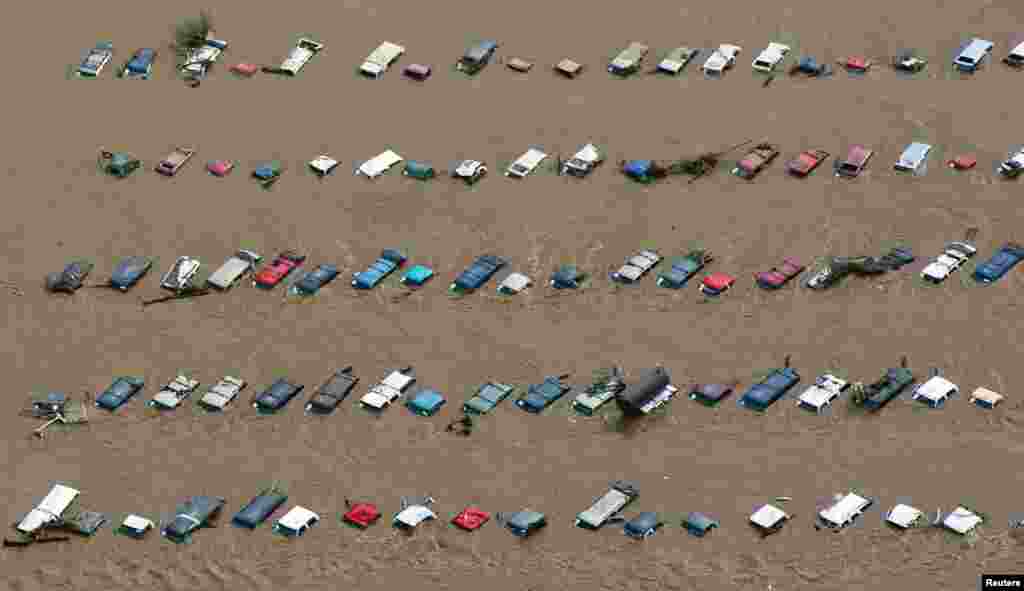 An aerial view of vehicles submerged in flood waters along the South Platte River near Greenley, Colorado, Sept. 14, 2013. 