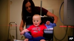 Kilian Daugherty, 1, is prepped for a chest X-ray by radiology technologist Kerah Adams as he's examined for flu symptoms at Upson Regional Medical Center in Thomaston, Ga., Feb. 9, 2018.