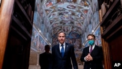 Secretary of State Antony Blinken, center, accompanied by tour guide Alessandro Conforti, right, and Chargé d'Affaires of the U.S. Embassy to the Holy See Patrick Connell, left, gets a tour of the Sistine Chapel at the Vatican in Rome, June 28, 2021.