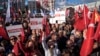 FILE - People chant slogans during a protest against the arrest and removal from office of a mayor from Turkey's main opposition party for alleged links to a banned Kurdish militant group, in Istanbul, Turkey, Oct. 31, 2024. 