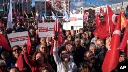 FILE - People chant slogans during a protest against the arrest and removal from office of a mayor from Turkey's main opposition party for alleged links to a banned Kurdish militant group, in Istanbul, Turkey, Oct. 31, 2024. 