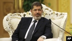 Egypt's President Mohammed Morsi meets with Chinese Vice President Xi Jinping, unseen, at the Great Hall of the People in Beijing, August 29, 2012. 