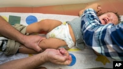 Pediatrician Charles Goodman vaccinates Cameron Fierro, 1, with the measles-mumps-rubella vaccine at his practice in Northridge, Calif., Jan. 29, 2015. 