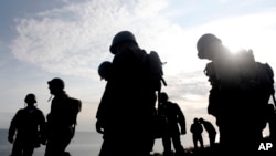 Soldiers from the U.S. 75th Ranger Regiment, in period dress stand on the overlook after climbing the cliffs of Pointe-du-Hoc in Cricqueville-en-Bessin, Normandy, France, June 5, 2019.