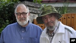 Cuba's former President Fidel Castro, right, poses for a picture with Mario Silva, a journalist from Venezolana de Television, in Havana, Cuba, September 4, 2011.