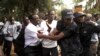 Ugandan policemen arrest opposition leader Kizza Besigye (front L) ahead of a rally to demonstrate against corruption and economic hardships in Uganda's capital Kampala, Jan. 19, 2012. 