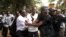 Ugandan policemen arrest opposition leader Kizza Besigye (front L) ahead of a rally to demonstrate against corruption and economic hardships in Uganda's capital Kampala, Jan. 19, 2012. 