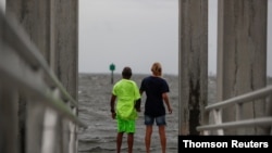Way Williams, 65, and his wife Jennifer, 60, hold hands at Bay Vista Park, as Elsa briefly strengthened into a Category 1 hurricane hours before an expected landfall on Florida's northern Gulf Coast, in St. Petersburg, Florida, July 6, 2021.
