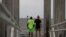 Way Williams, 65, and his wife Jennifer, 60, hold hands at Bay Vista Park, as Elsa briefly strengthened into a Category 1 hurricane hours before an expected landfall on Florida's northern Gulf Coast, in St. Petersburg, Florida, July 6, 2021.