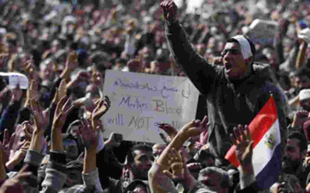 Anti-government protesters react in Tahrir Square, Cairo, Egypt, Friday, Feb. 4, 2011.