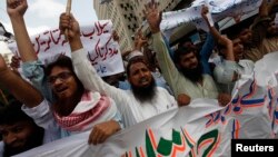 FILE - Supporters of the Jamaat-ud-Dawa organization chant slogans during a protest rally in Karachi, June 27, 2014. 