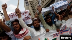 FILE - Supporters of the Jamaat-ud-Dawa organization chant slogans during a protest rally in Karachi, June 27, 2014. 