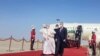 Iraqi Prime Minister Mustafa Al-Kadhimi walks with Pope Francis upon his arrival at Baghdad International Airport, in Baghdad, Iraq, March 5, 2021. 