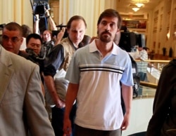 FILE - U.S. journalist James Foley, center, arrives in Tripoli, May 18, 2011.