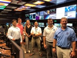 Erin and Kelly with interns at the Marshall Space Flight Center's Payloads Operations Integration Center (POIC) in Huntsville, Alabama in the summer of 2019 during Erin's internship.