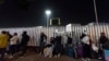 FILE - Migrants from Cuba and Venezuela line up at a Mexican immigration checkpoint as they make their way across the border for appointments to legally apply for asylum in the United States, Nov. 5, 2024, in Tijuana, Mexico.