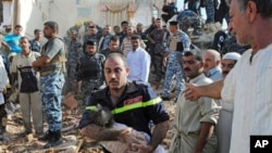 An Iraqi emergency worker carries the lifeless body of 6-month-old Shahad Mohammed from the bombed out ruins of his home in Tikrit, 80 miles (130 kilometers) north of Baghdad, 19 Oct 2010