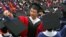 FILE: A man adjusts a student's mortar board during the graduation ceremony at Fudan University in Shanghai. Taken 6.28.2006
