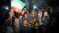 A group of jubilant Iranians cheer and spray artificial snow during street celebrations following the announcement of a landmark nuclear deal, in Tehran, July 14, 2015.