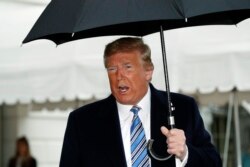 President Donald Trump speaks about the coronavirus as he walks to Marine One to depart the White House, March 28, 2020, in Washington.