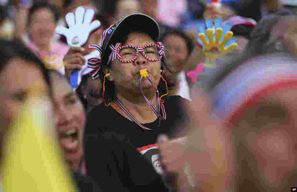 An anti-government protester blows a whistle during a rally at the Democracy Monument in Bangkok, Dec. 6, 2013.&nbsp;