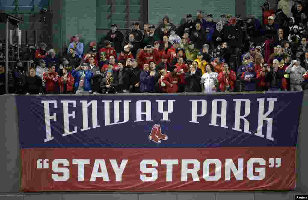  Baseball fans sit above a sign in the bleachers that reads "stay strong" as part of the Boston Strong campaign before game one of the MLB baseball World Series. Mandatory Credit: Robert Deutsch-USA TODAY Sports