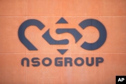 FILE - FILE - A logo adorns a wall on a branch of the Israeli NSO Group company, near the southern Israeli town of Sapir, August 24, 2021.