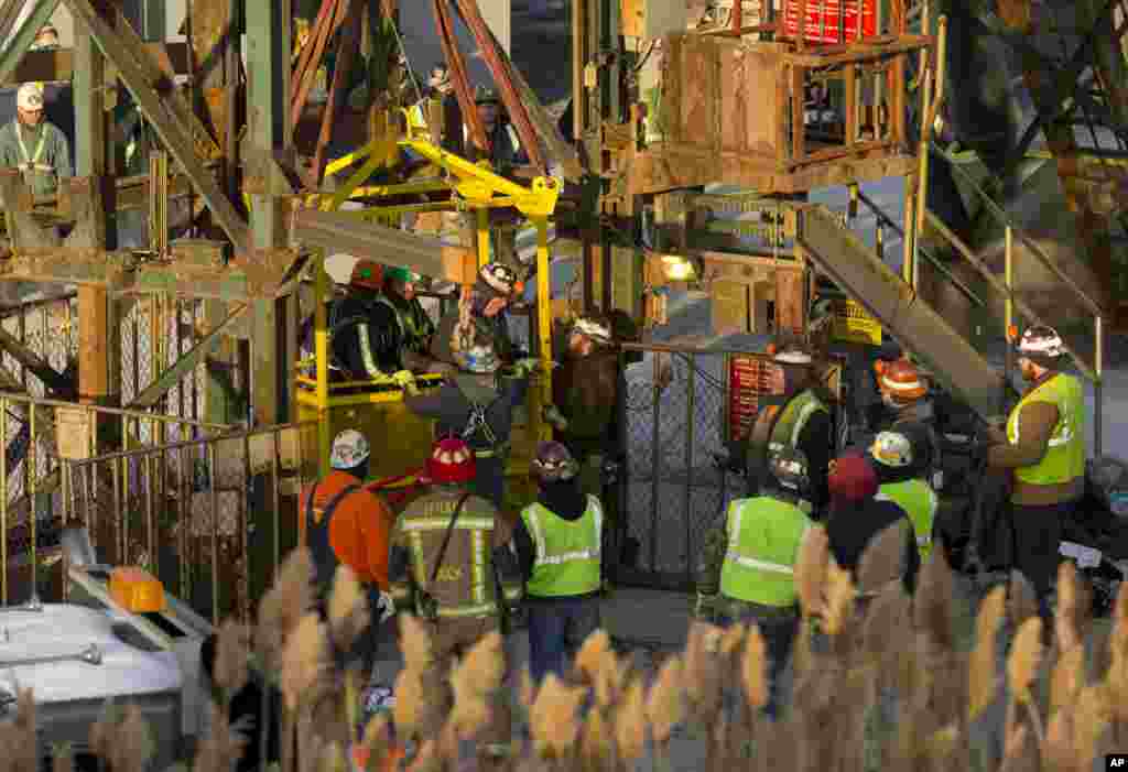 The last of 17 Cargill salt miners emerge after being rescued from an elevator stuck 900 feet below the surface at the Cayuga Salt Mine in Lansing, New York. A rescue cage was lowered from a crane to bring them up four at a time.