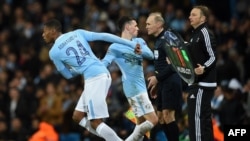 Le défenseur de Manchester City Tosin Adarabioyo, à gauche, remplace le milieu de terrain Phil Foden lors du match retour de la Ligue des champions contre Bâle au Stade Etihad de Manchester, Angleterre, 7 mars 2018.