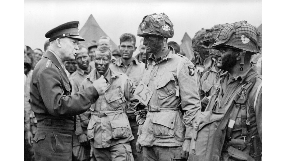 General Dwight D. Eisenhower encouraging paratroopers on June 5, 1944, before they board their planes to participate in the first assault of the Normandy invasion during World War II. (Courtesy - Eisenhower Library and Museum)