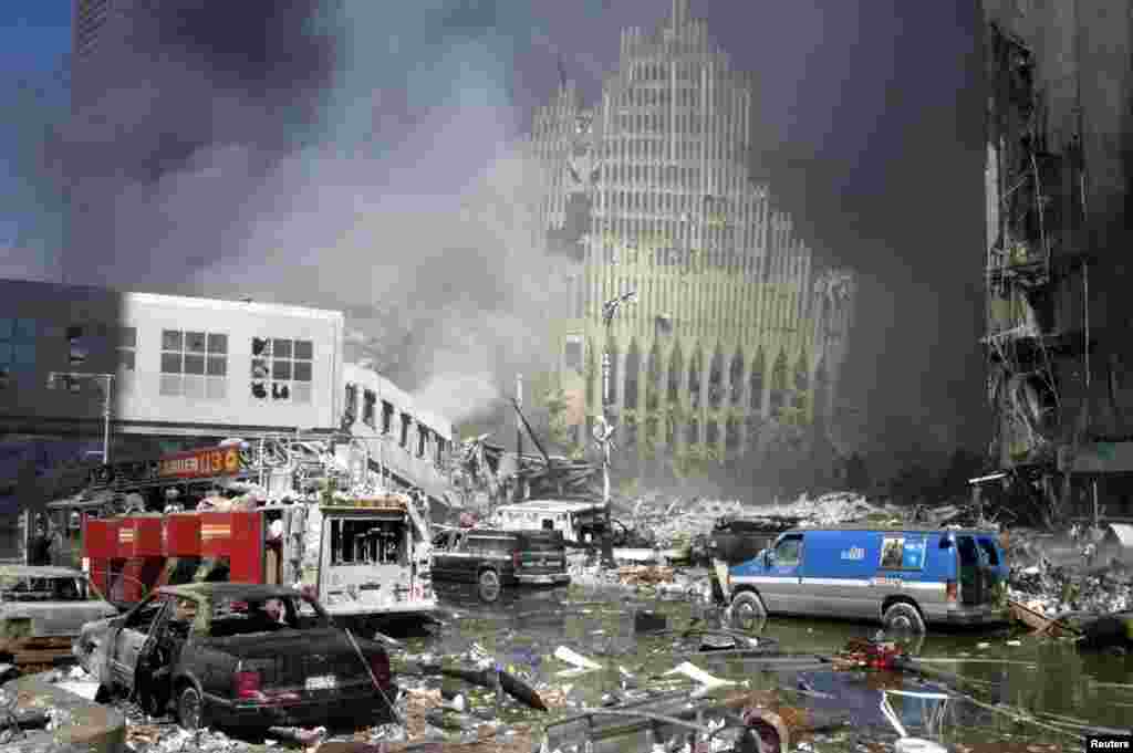 Fire trucks sit amid the rubble near the base of the destroyed World Trade Center in New York.