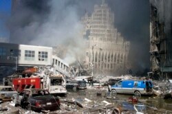 File - Firetrucks sit amid the rubble near the base of the destroyed World Trade Center in New York on September 11, 2001. Two hijacked commercial planes slammed into the twin towers of the World Trade Center Tuesday,