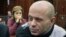 Politkovskaya's daughter Vera, background, looks at former police officer Dmitry Pavlyuchenko, right, prior to the judge's verdict, at the Moscow City Court, Russia, December 14, 2012