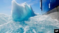 FILE - In this July 21, 2017 file photo, broken sea ice emerges from under the hull of the Finnish icebreaker MSV Nordica as it sails through the Victoria Strait while traversing the Arctic's Northwest Passage. After 24 days at sea and a journey spanning