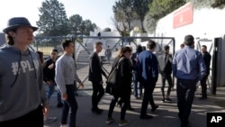 High school students enter the Alexis de Tocqueville school in Grasse, southern France, the day after a 16-year-old student opened fire, wounding three other students and the principal, March 17, 2017. 