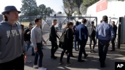 High school students enter the Alexis de Tocqueville school in Grasse, southern France, the day after a 16-year-old student opened fire, wounding three other students and the principal, March 17, 2017. 